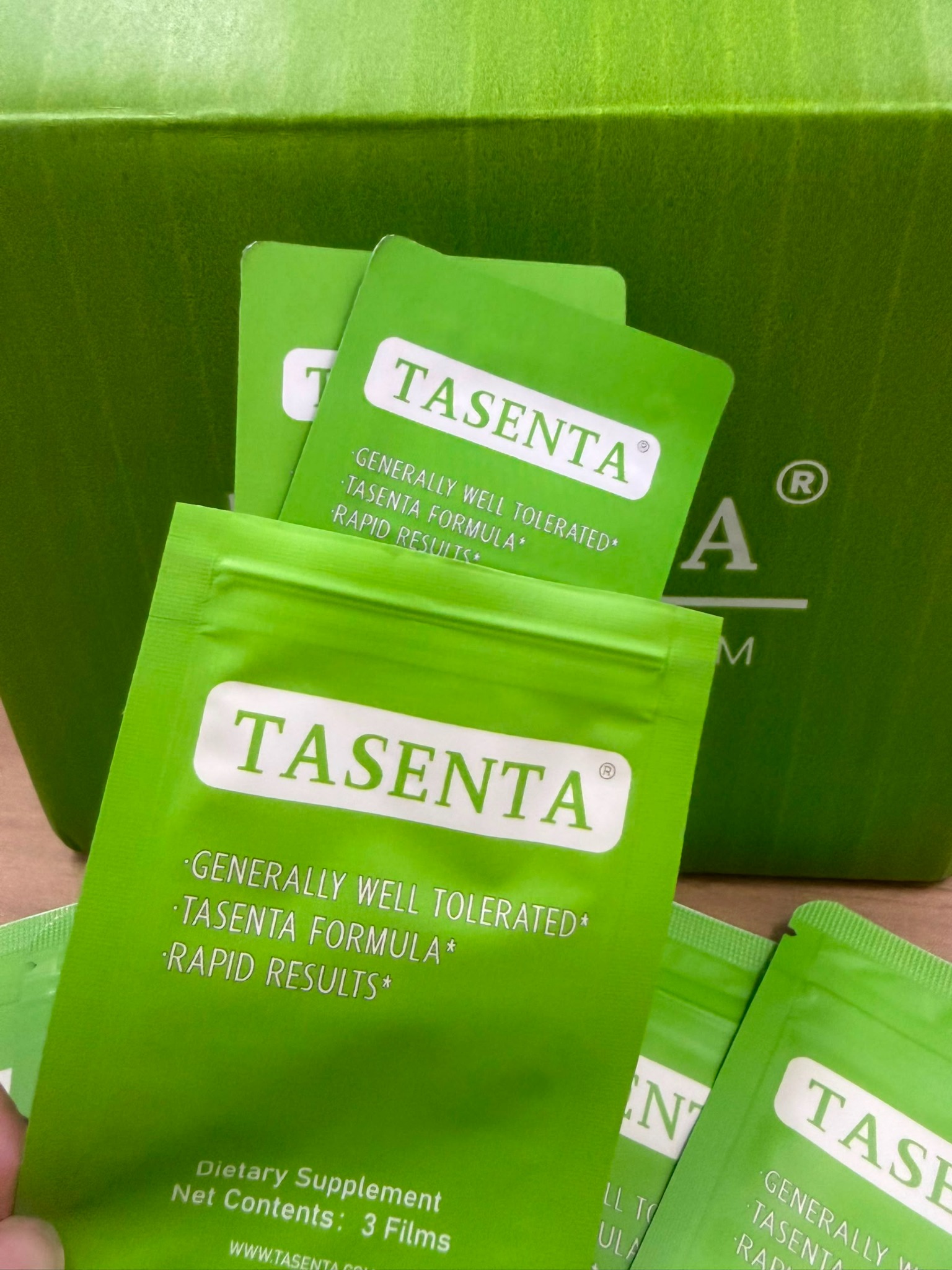 An open TASENTA pouch with individual film packets